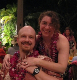 Anne and Brian, engaged and happy at a luau in Oahu